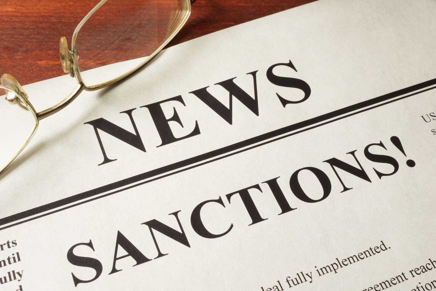 A news briefing on a desk that reads sanctions
