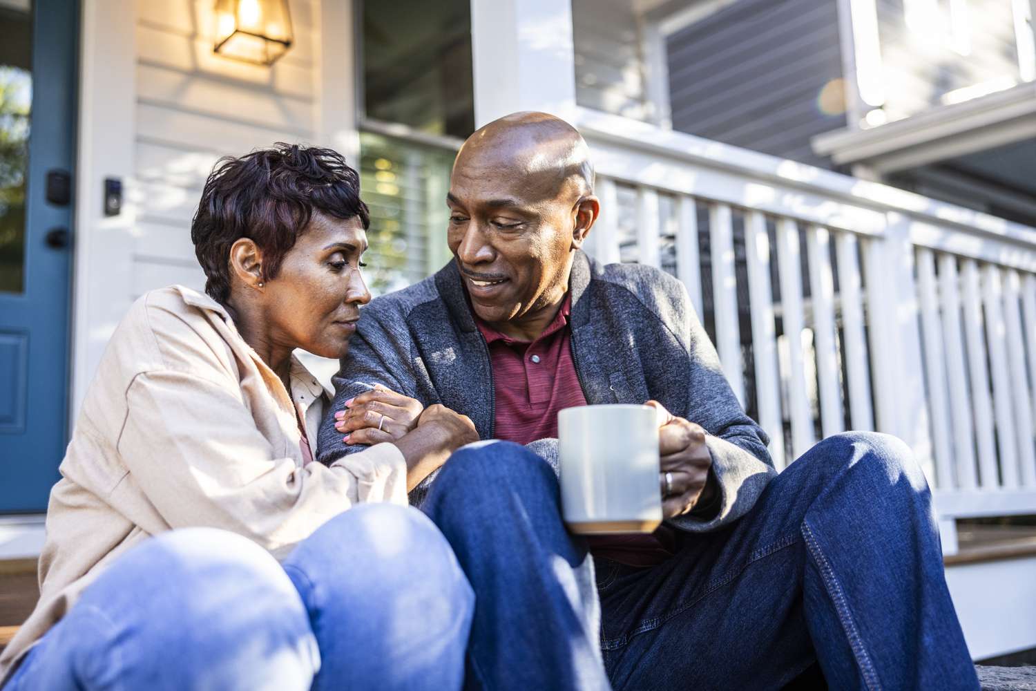 A couple sitting on front porch