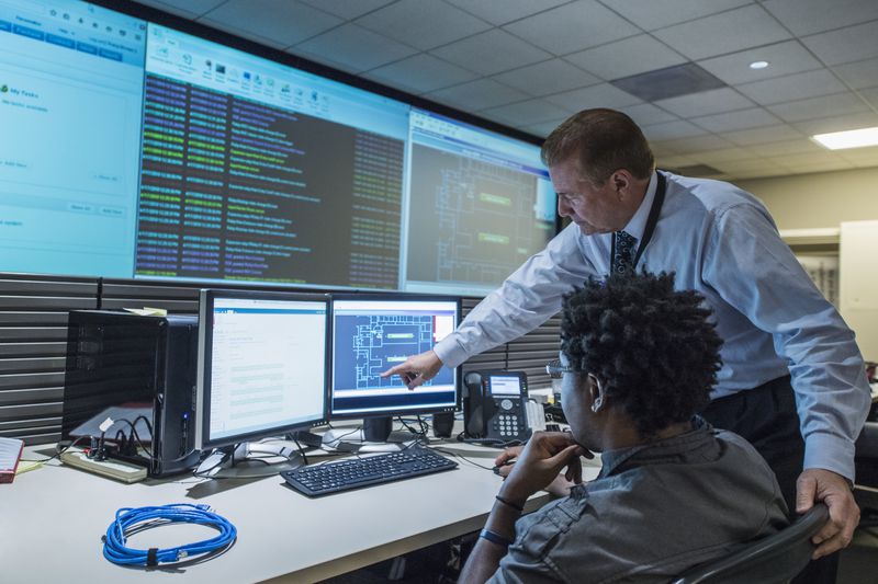 Colleagues working together in server control room
