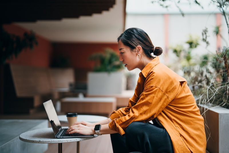 Worker at laptop outside