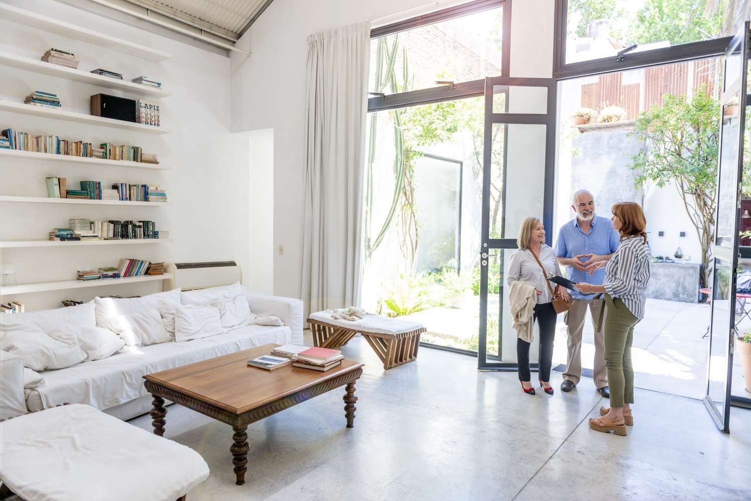 An older couple is viewing a house shown by the listing agent/realtor that will be commissioned under extender clause.