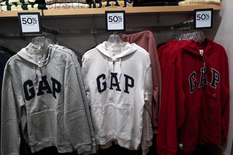 A gray, white, and red Gap sweatshirt are seen on display at a Gap store.