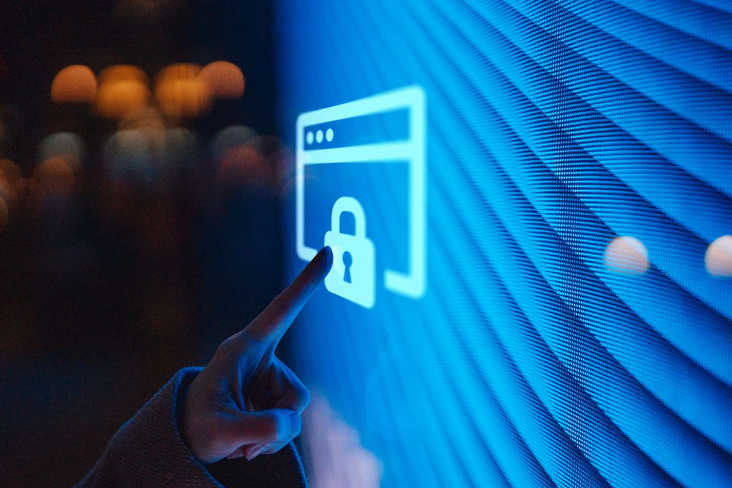 Close-up of female hand touching illuminated digital screen displaying a lock icon.