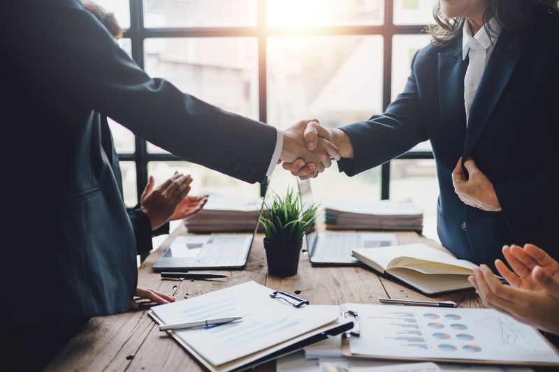 Business people shaking hands to congratulate success.