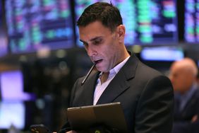 Trader on the floor of the Stock Exchange studying data