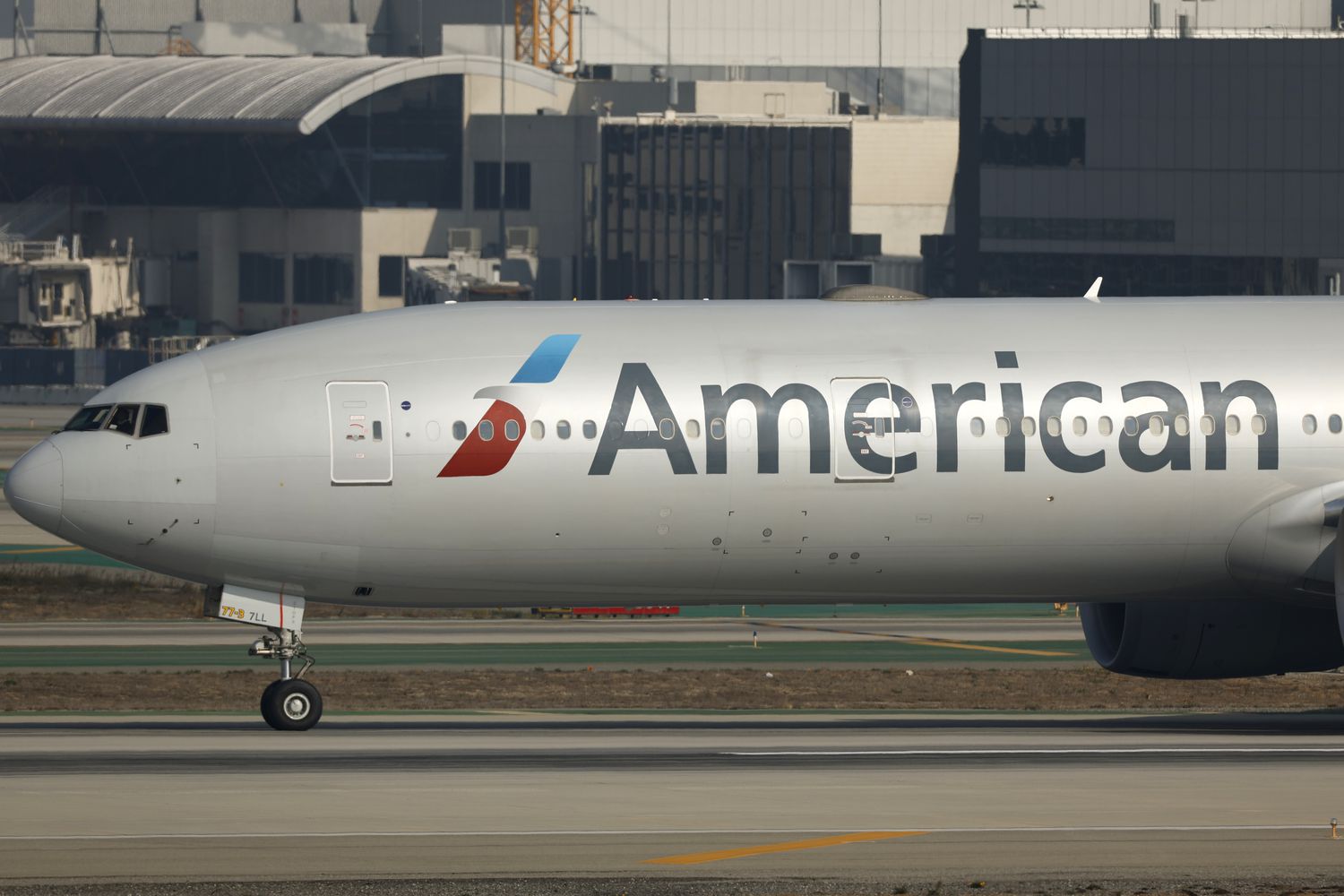An airplane with the American Airlines logo on the side sits on a runway.