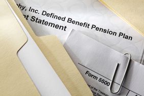 Close-up of defined benefit pension plan papers and a file folder