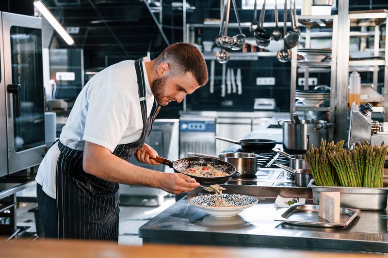 A chef makes a pasta dish.