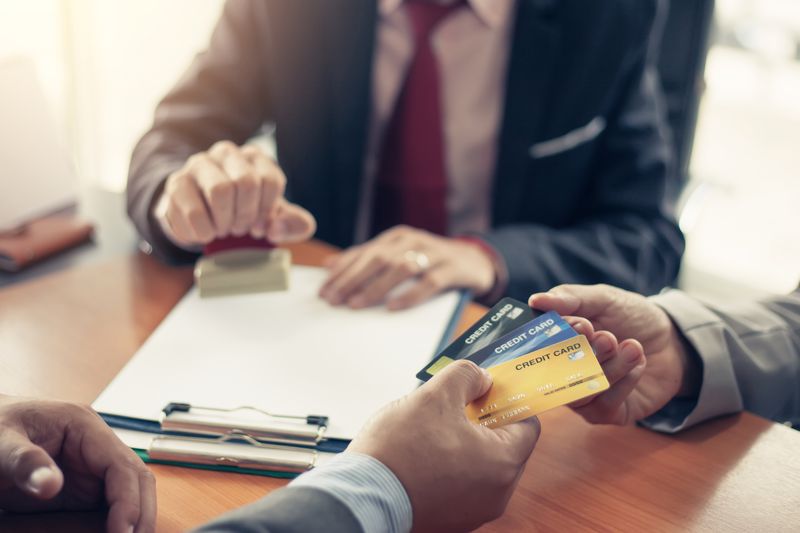 Two people exchanging credit cards