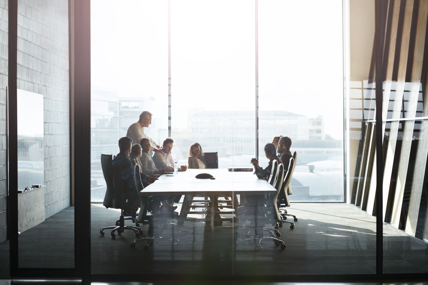 CEO giving talk to businesspeople at meeting in big conference room