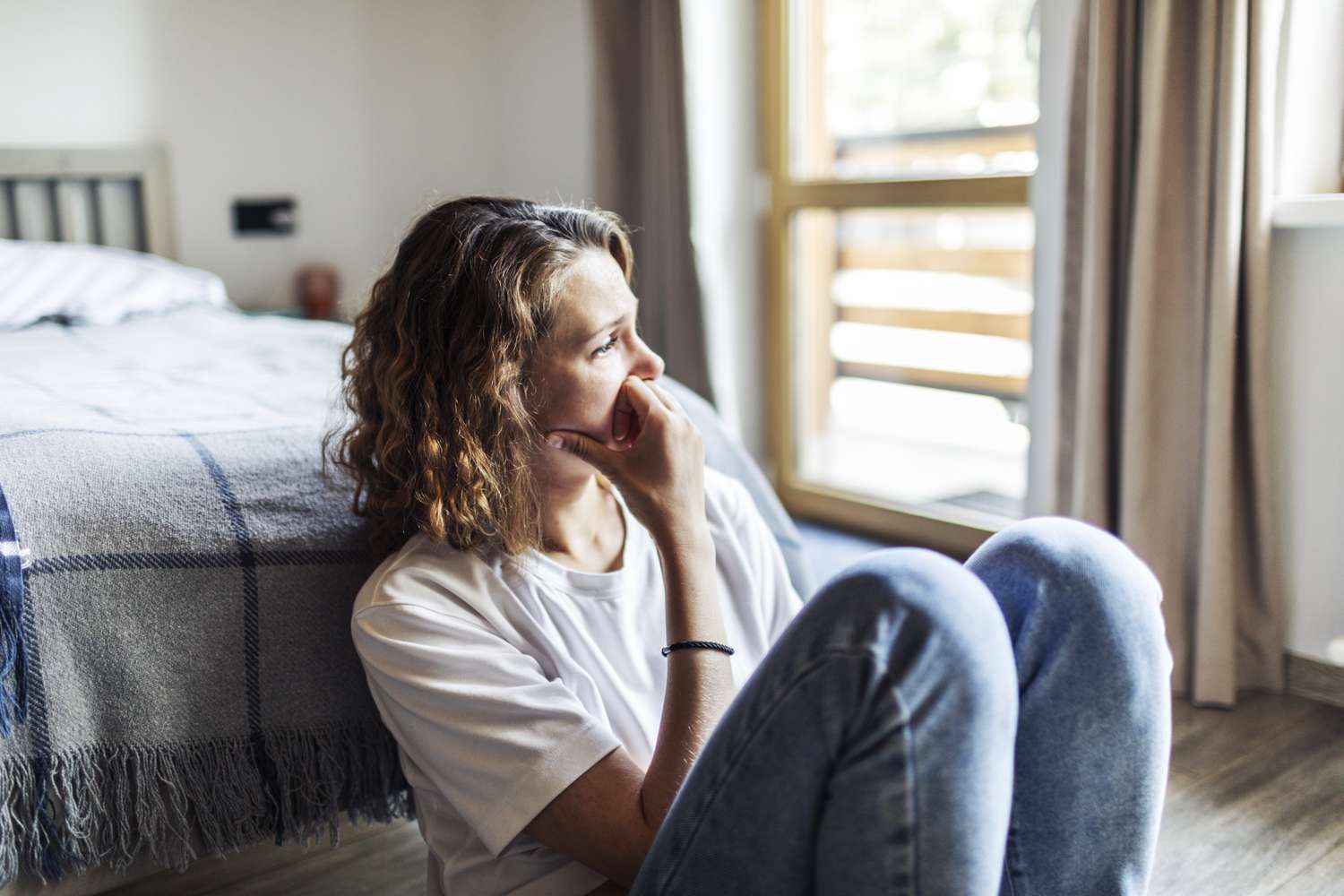An upset woman sitting on the floor