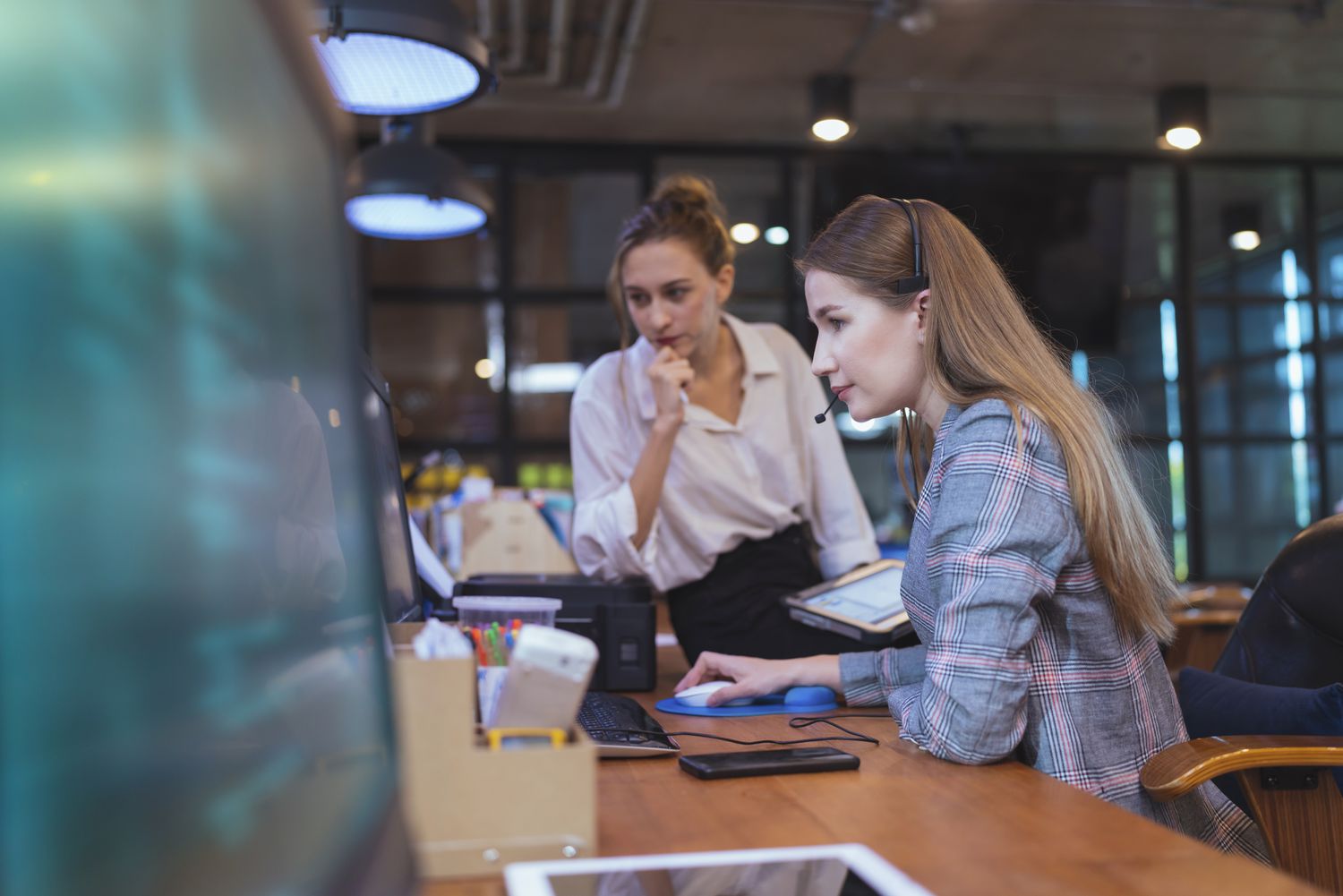 Two women looking at a computer screen