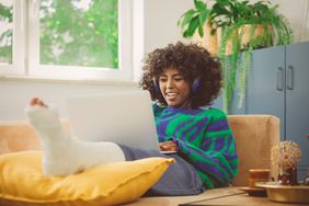 Young woman with leg in a plaster cast looks for short-term disability insurance companies.