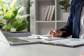 A person with computer and calculator