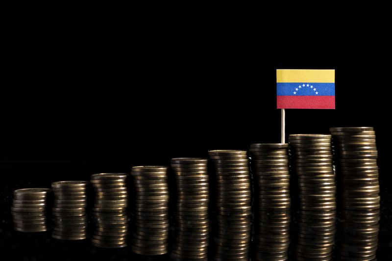 Venezuelan flag and stacks of coins