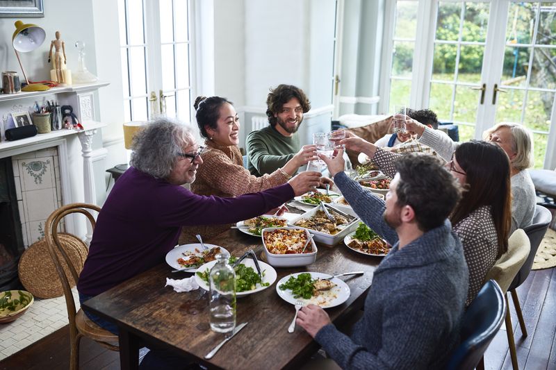 Parents and children toasting in a family dinner.
