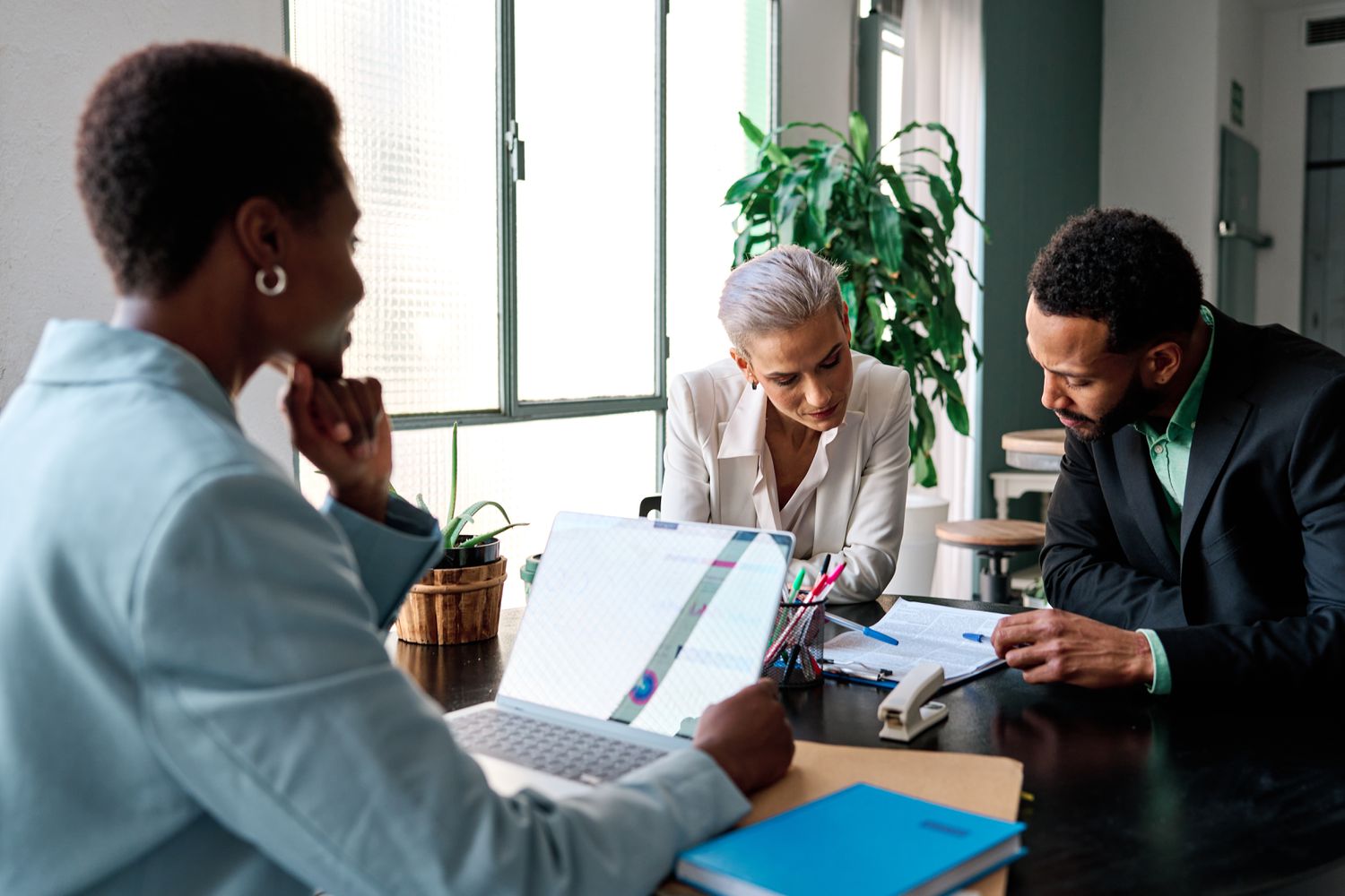 Fund managers for a collateralized mortgage obligation fund meet in an office to discuss the seperation of loans into tranches.
