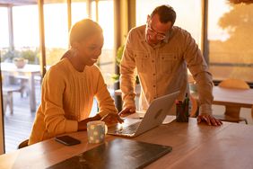 A man and woman searching for stocks for their portfolio