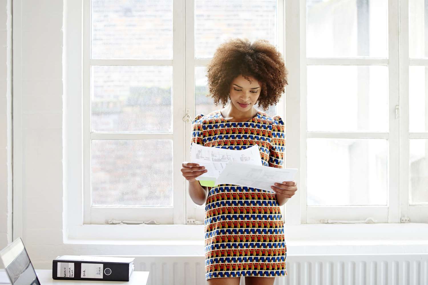 Young woman looks over her credit card statement