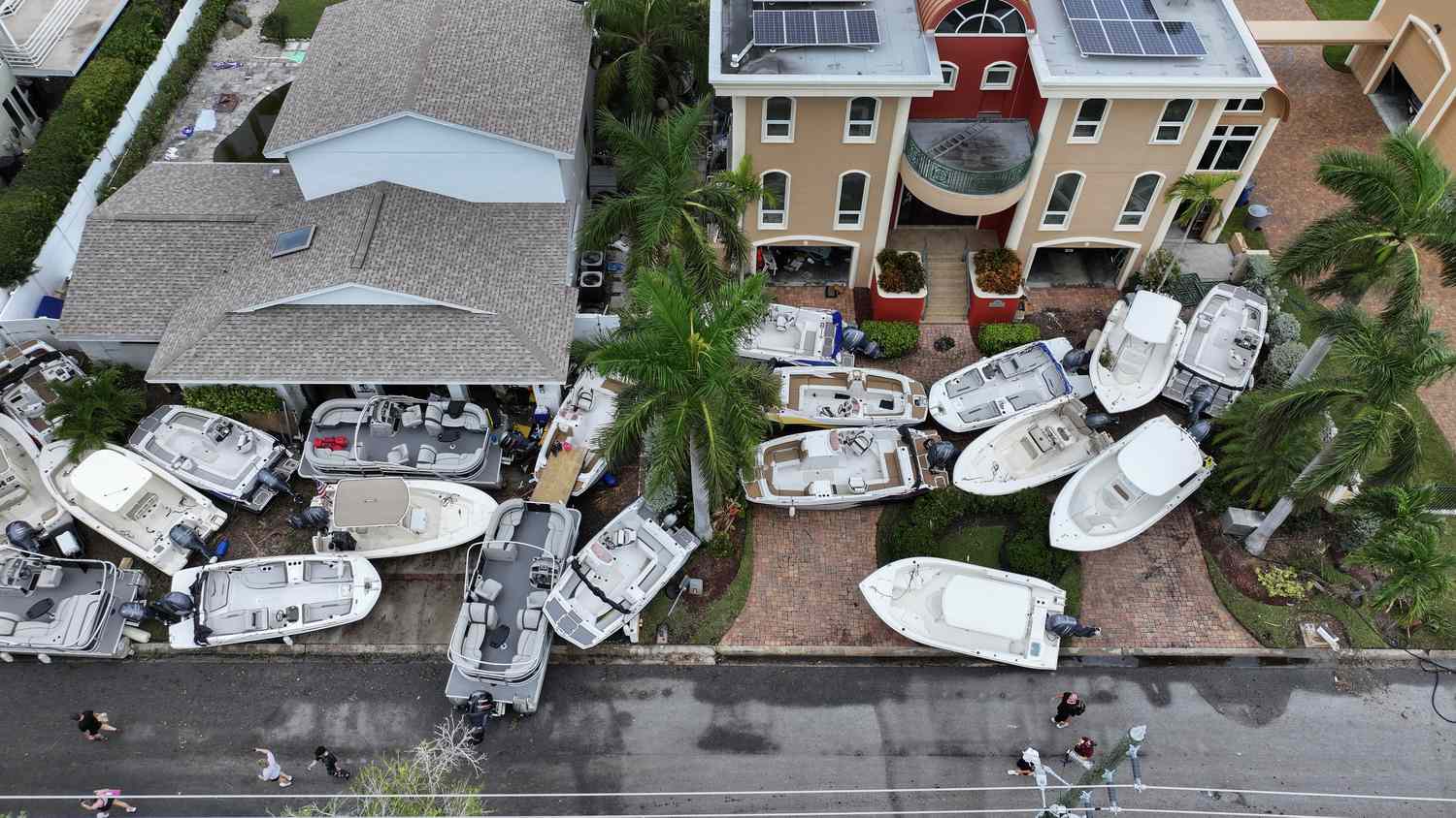 Hurricane Helene devastation as boats are carried up to land in front of residential homes.