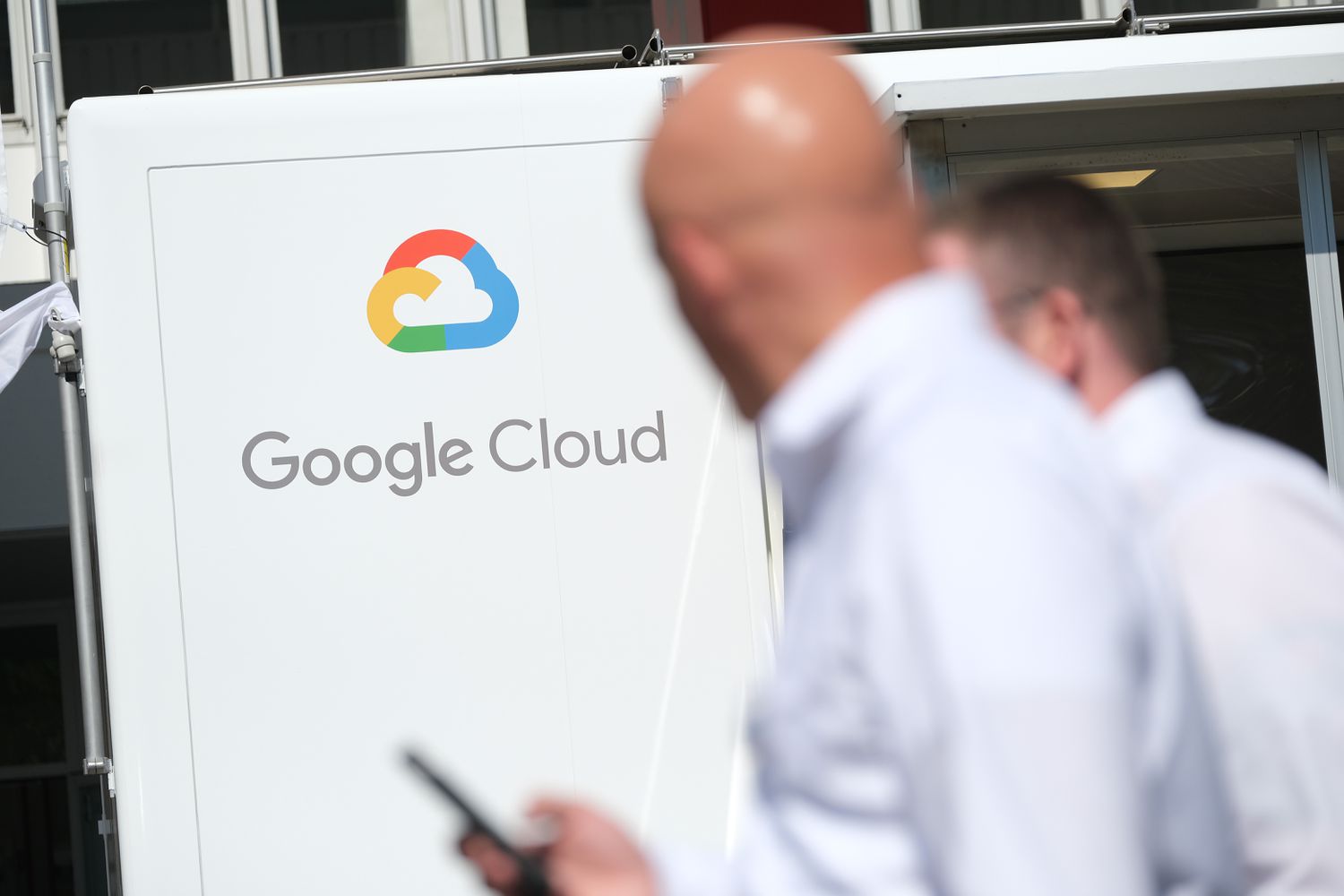 People walk past a Google Cloud exhibit during the press days at the 2019 IAA Frankfurt Auto Show.