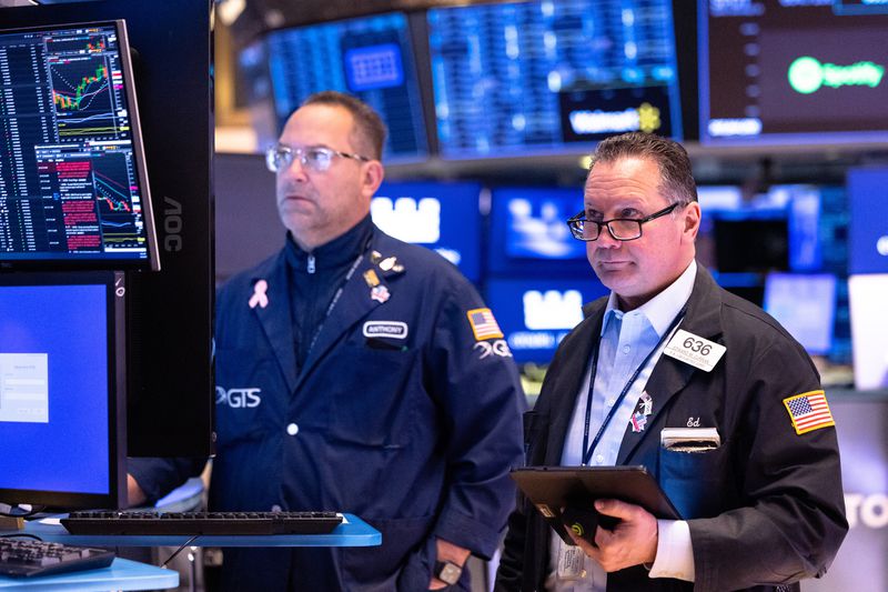 Traders work on the floor of the New York Stock Exchange during morning trading on March 25, 2025 in New York City.