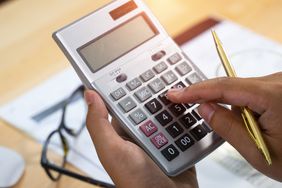 A woman's hands counts on the calculator.