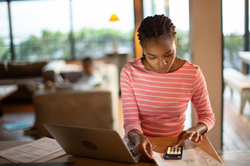 A 20-something person calculating investments.