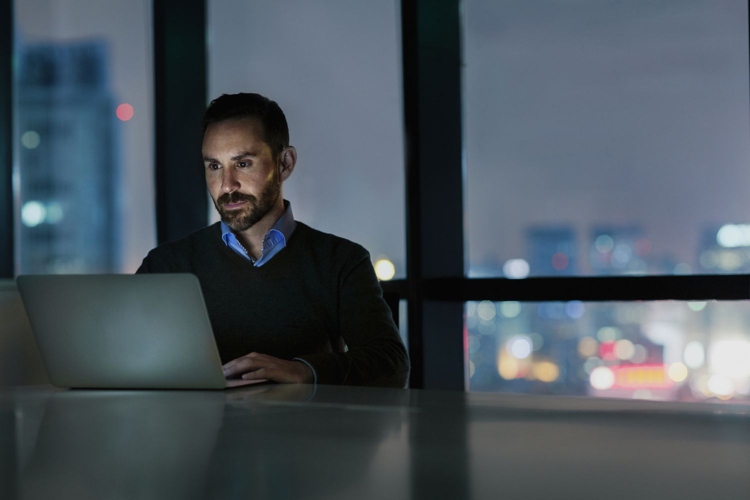 Person using a laptop after dark