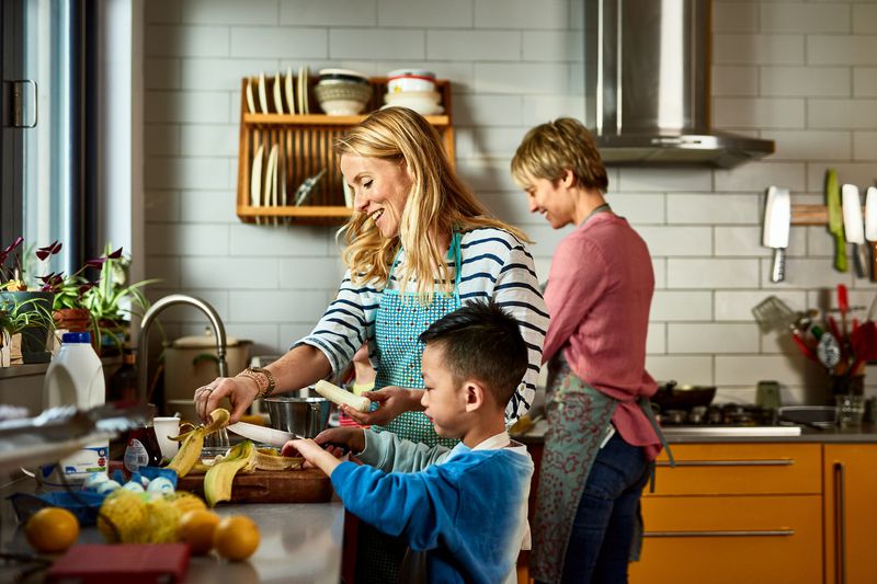 A family cooks a meal in its home.