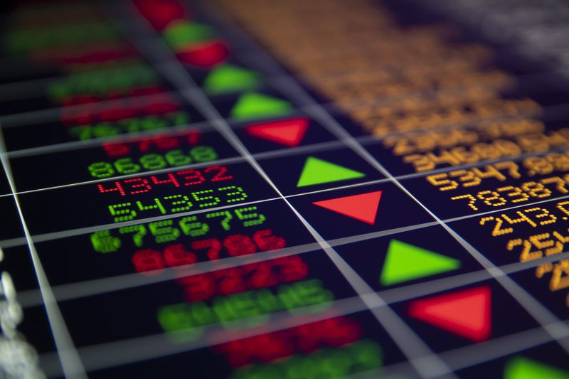 financial data board containing numbers and arrows