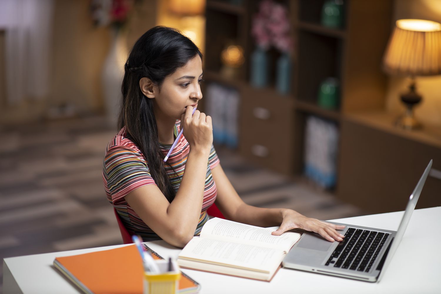 Student reads on her laptop about how changes brought about by the Education Department's shutdown might affect her