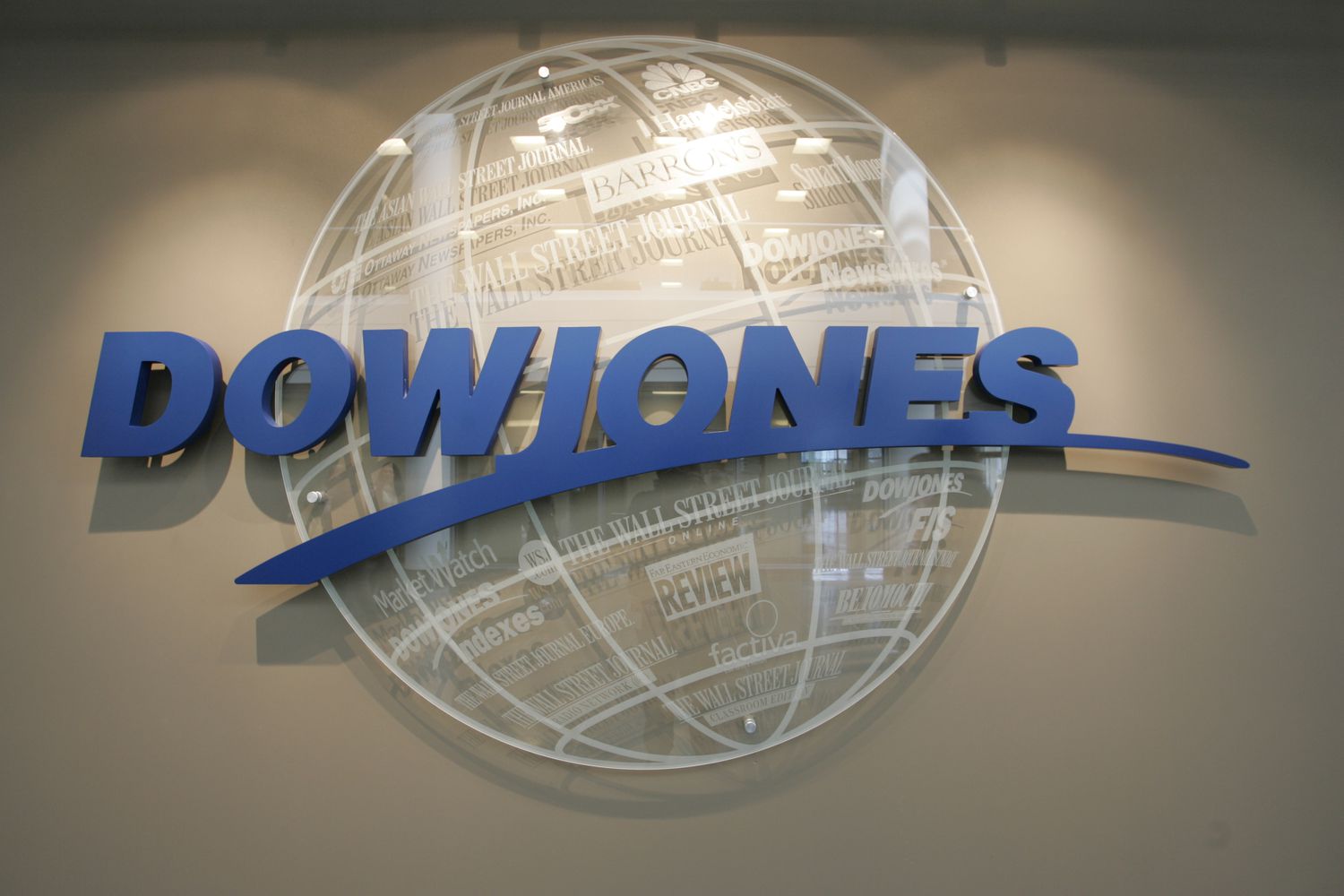 The logo for Dow Jones & Company appears on an office wall.