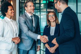 Colleagues discussing how to roll over a 401(k) from their old job to their new one