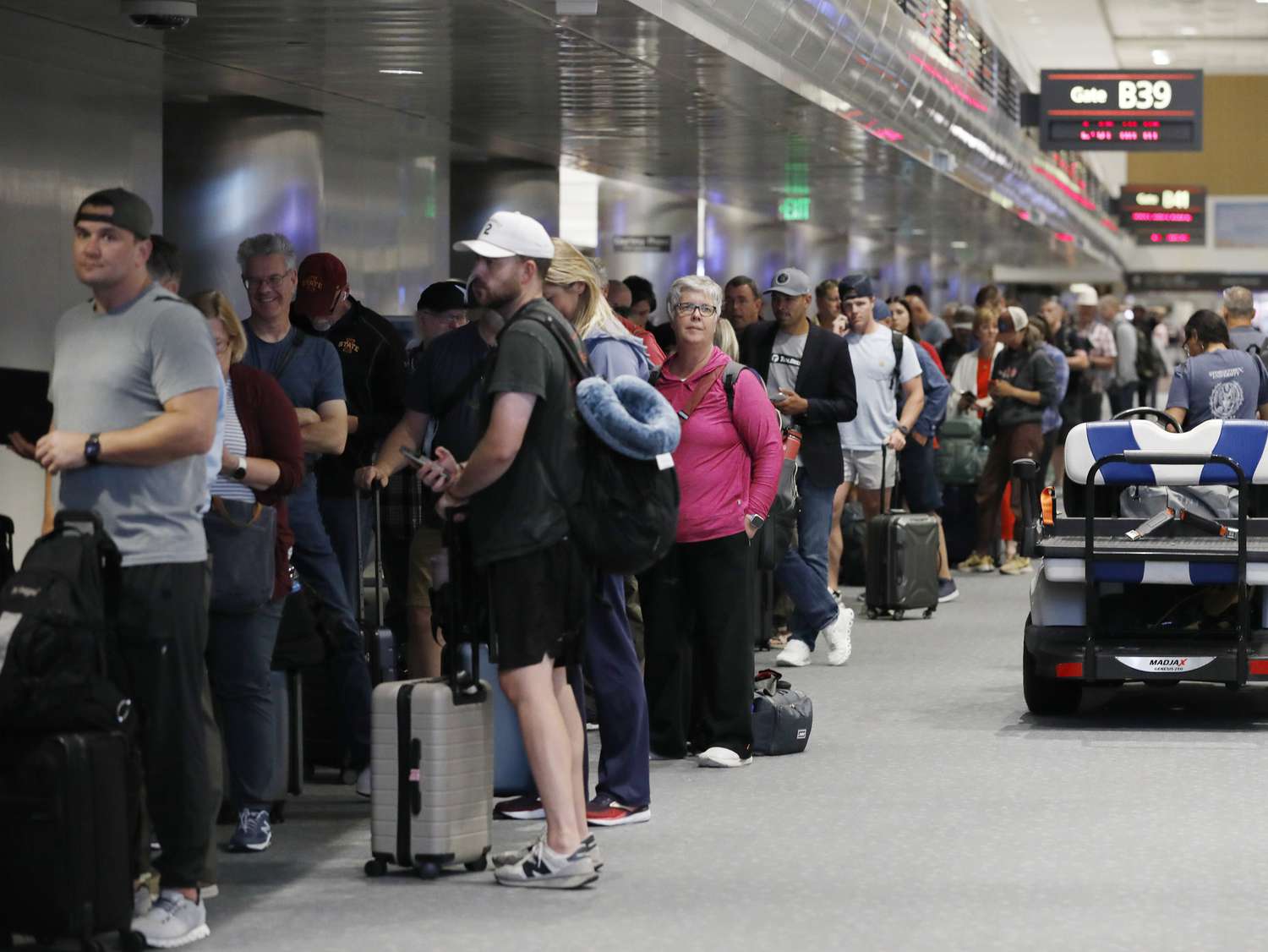 Passengers crowd in the departure lounge of Denver International Airport on July 20, 2024 in Denver, Colorado
