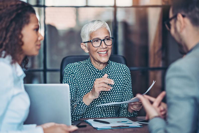 A businesswoman talking to her team.