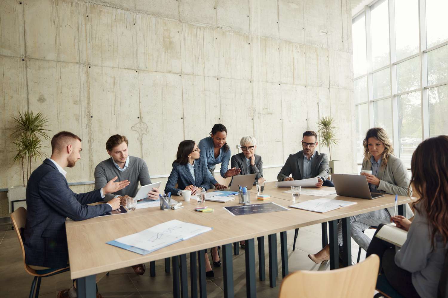 Corporate team at conference table discussing a takeover bid