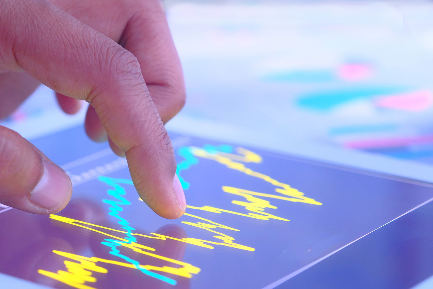 Close up of Young Man Hand Analyzing Stock Market Data