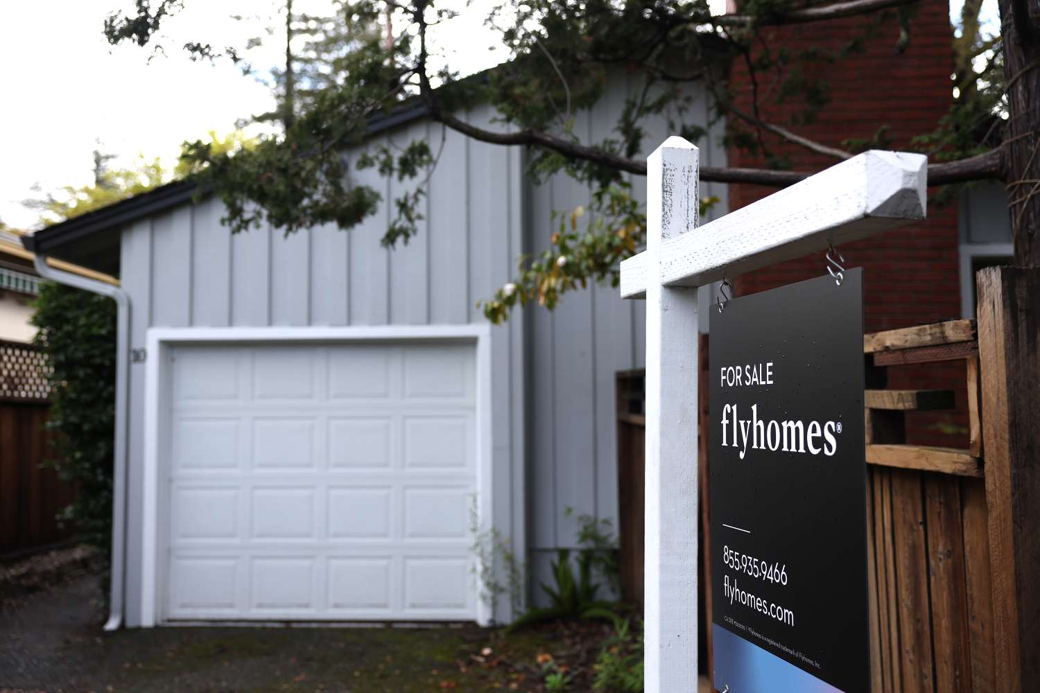 A for sale sign is posted in front of a home.