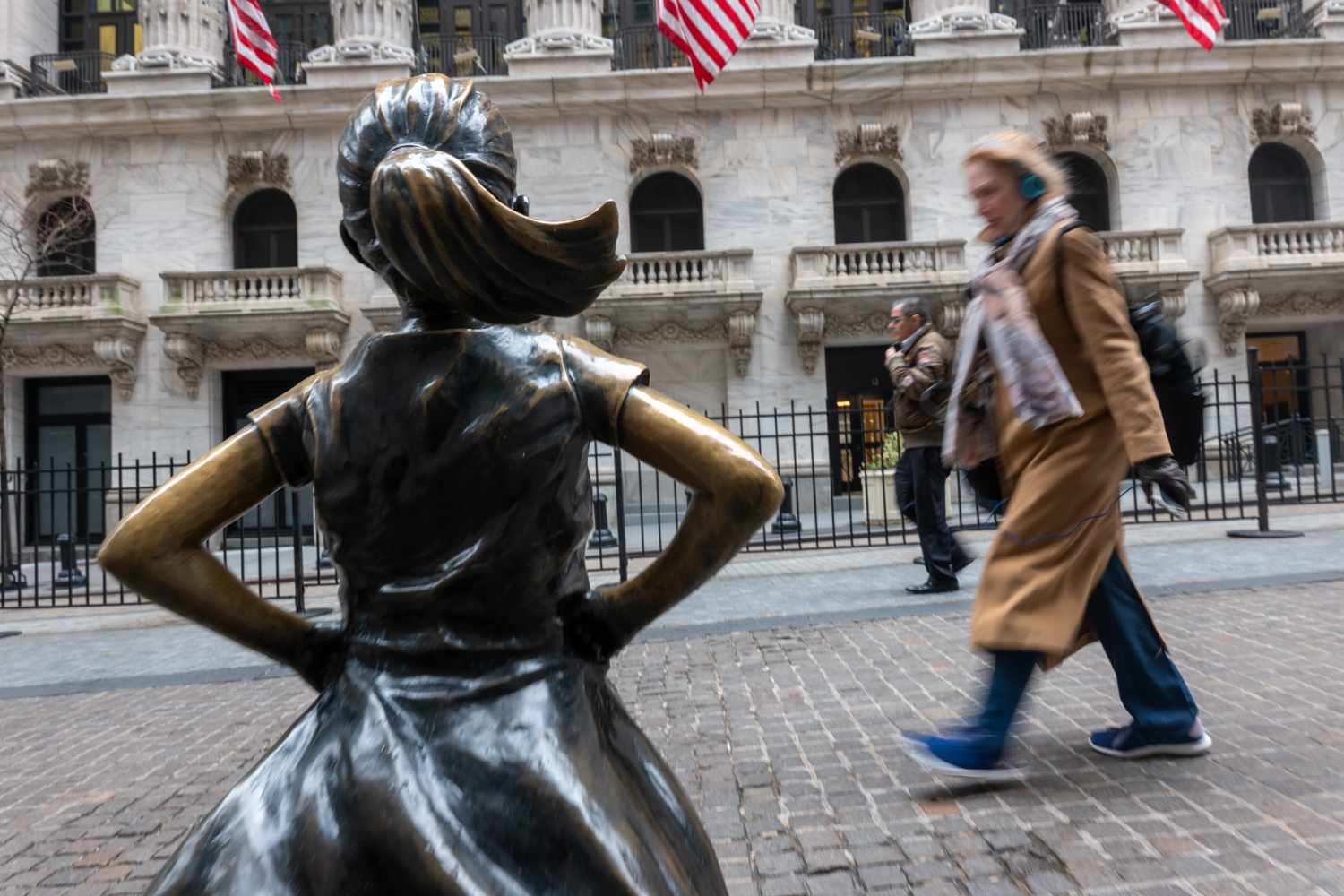 People walk by the New York Stock Exchange (NYSE).