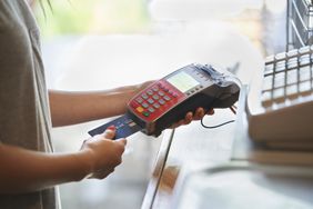 Woman paying with credit card terminal