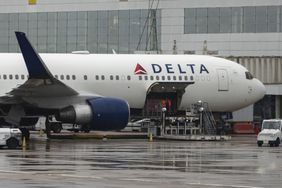 A Delta Air Lines Boeing 767-300 at an airport gate