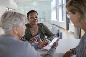 financial meeting with mother and daughter using smart phone in bank