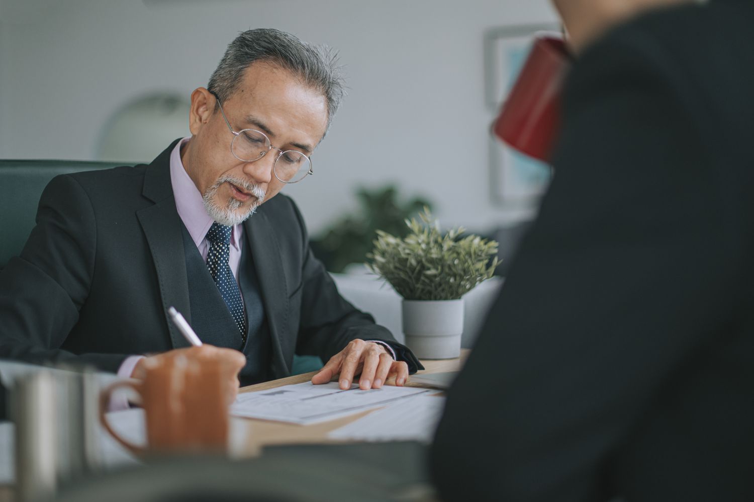 Government official filling out paperwork related to a federal grant-in-aid