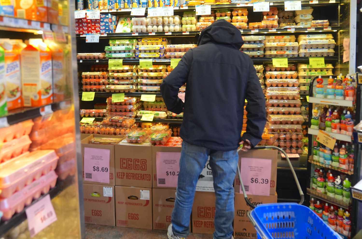 A customer is seen during shopping at a supermarket as packages of eggs are seen on the shelves of the egg aisle in New York City