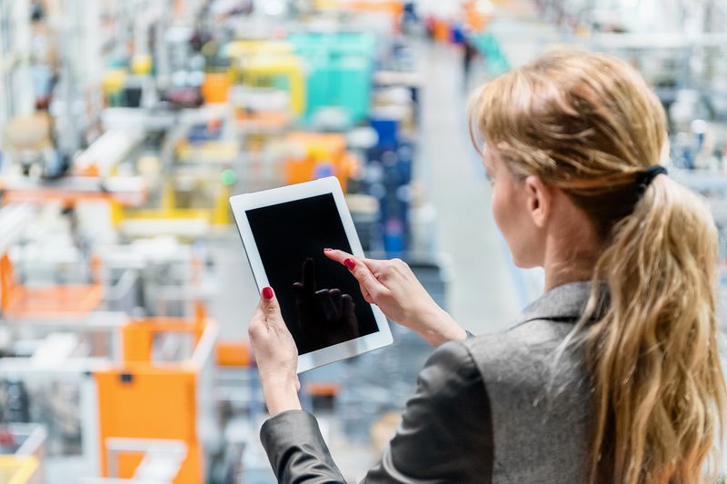 Woman in Plastic Factory Working With Tablet