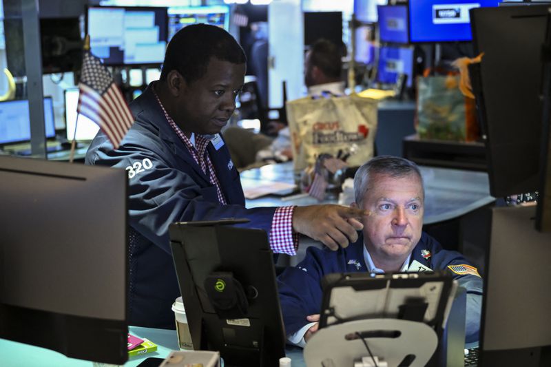 Traders work on the floor of the New York Stock Exchange