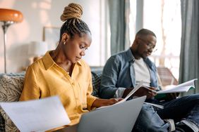 Couple looking over documents for their reverse mortgage in their two-family home.