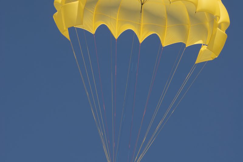 A duo floating on a golden parachute