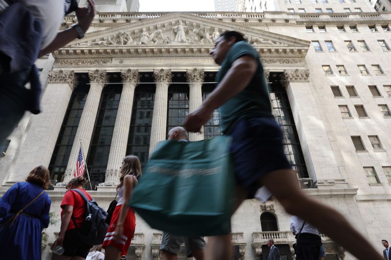 People walk by the New York Stock Exchange in New York City.